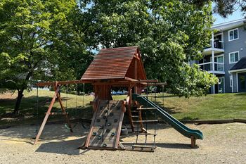 A playground with a swing set and a slide